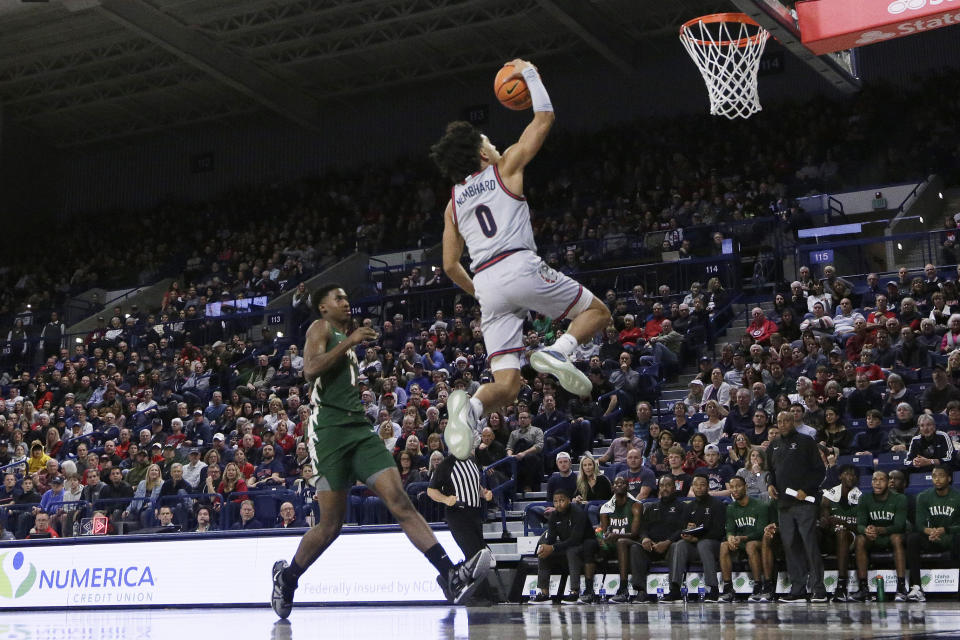 Gonzaga guard Ryan Nembhard (0) drives to the basket next to Mississippi Valley State guard Chidi Umeh (1) during the first half of an NCAA college basketball game, Monday, Dec. 11, 2023, in Spokane, Wash. (AP Photo/Young Kwak)