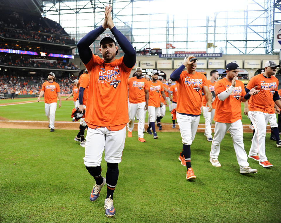 Houston Astros' George Springer, left, celebrates the team's clinching of the AL West crown after a baseball game against the Los Angeles Angels, Sunday, Sept. 22, 2019, in Houston. (AP Photo/Eric Christian Smith)