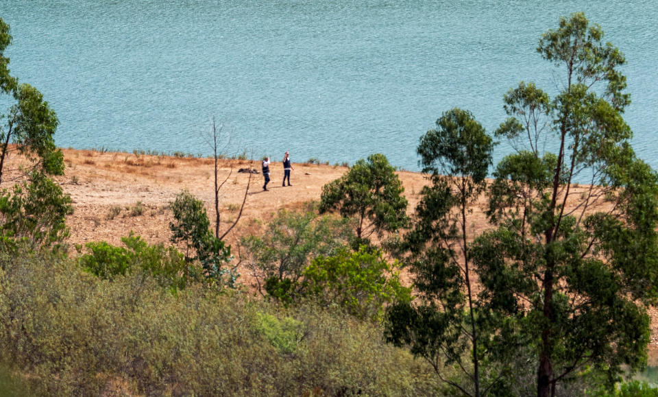 Officers of Portugal's investigative Judicial Police are seen at the site of a remote reservoir where a new search for the body of Madeleine McCann is set to take place, in Silves, Portugal, in this screen grab from a video, May 22, 2023. REUTERS/Luis Ferreira