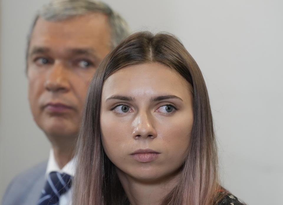 Belarusian dissident in Poland, Pavel Latushka, left, and Belarusian Olympic sprinter Krystsina Tsimanouskaya, right, who came to Poland fearing reprisals at home after criticizing her coaches at the Tokyo Games, talk to journalists in Warsaw, Poland, Thursday, Aug. 5, 2021. (AP Photo/Czarek Sokolowski)