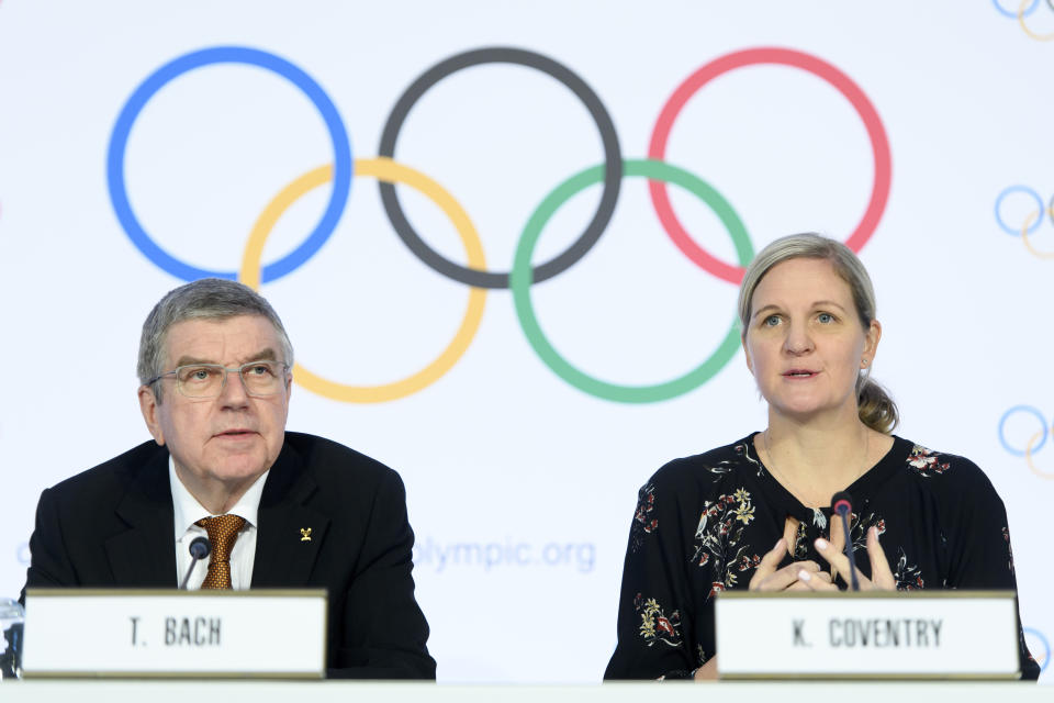 International Olympic Committee (IOC) president Thomas Bach, left, and IOC member and former swimmer Kirsty Coventry, right, speak during a press conference after the executive board meeting of the IOC, at the Olympic House, in Lausanne, Switzerland, Thursday, Jan. 9, 2020. (Laurent Gillieron/Keystone via AP)