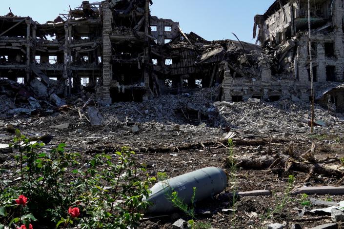 An unexploded bomb in front of a destroyed building in Mariupol, Ukraine