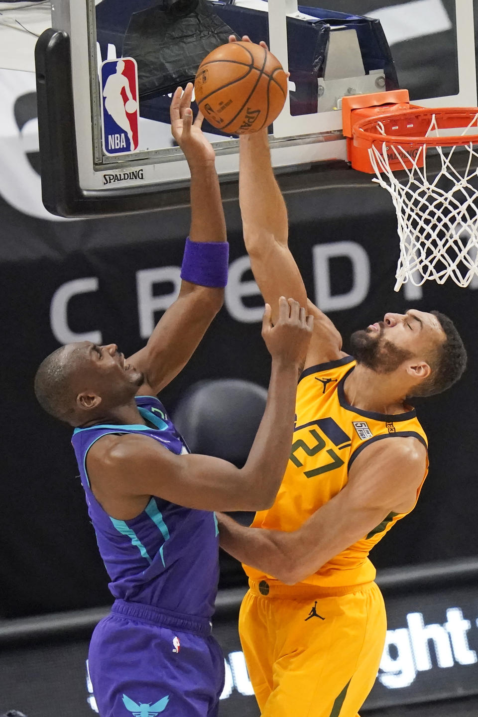 Utah Jazz center Rudy Gobert (27) blocks the shot from Charlotte Hornets center Bismack Biyombo, left, in the first half during an NBA basketball game Monday, Feb. 22, 2021, in Salt Lake City. (AP Photo/Rick Bowmer)