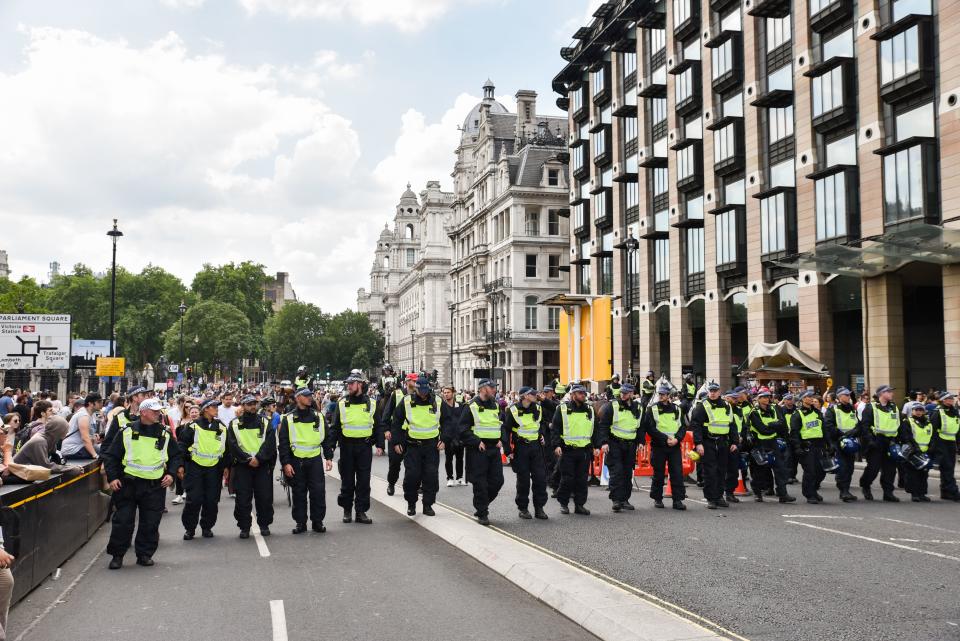 <p>Police officers form a line to keep anti-fascist groups from confronting a demonstration by Trump supporters and a Free Tommy Robinson group on Whitehall, London, July 14, 2018. (Photo: Matthew Chattle/REX/Shutterstock) </p>