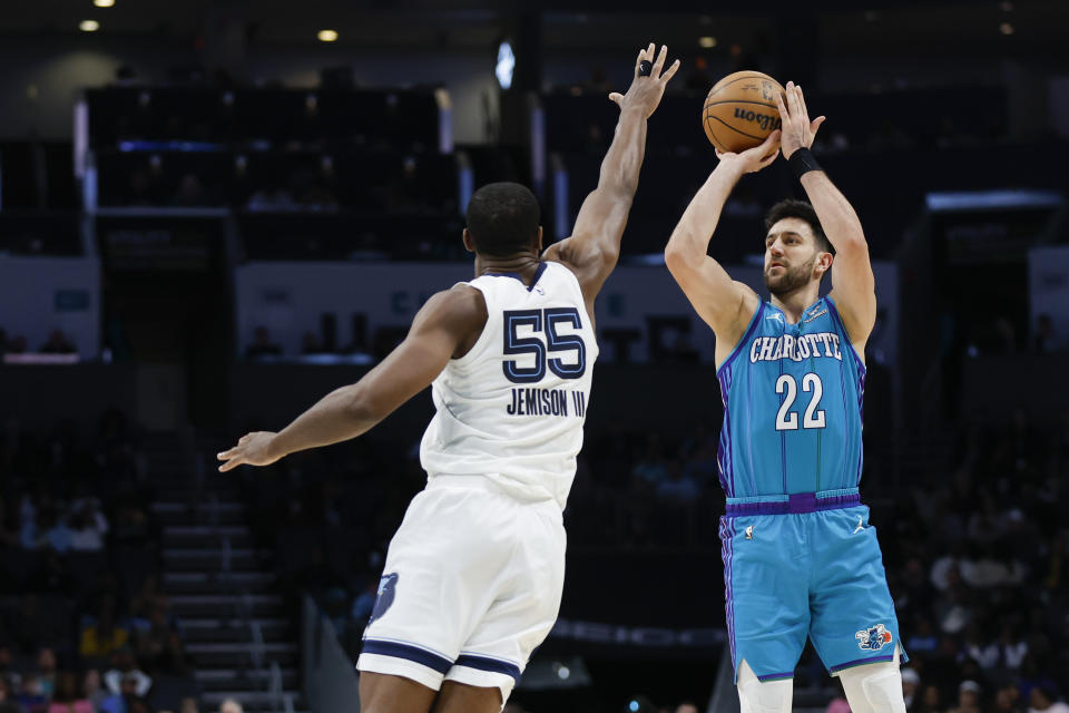 Charlotte Hornets guard Vasilije Micic (22) shoots over Memphis Grizzlies center Trey Jemison, left, during the second half of an NBA basketball game in Charlotte, N.C., Saturday, Feb. 10, 2024. (AP Photo/Nell Redmond)