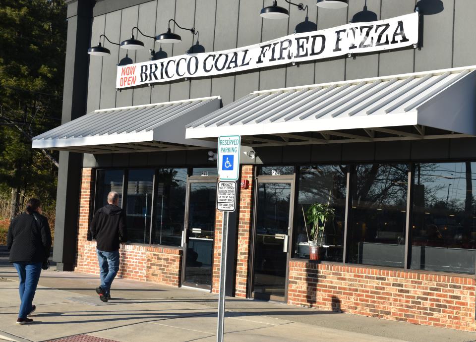 Customers enter the new Cherry Hill location of Bricco Coal Fired Pizza at Cross County Plaza on Route 70.