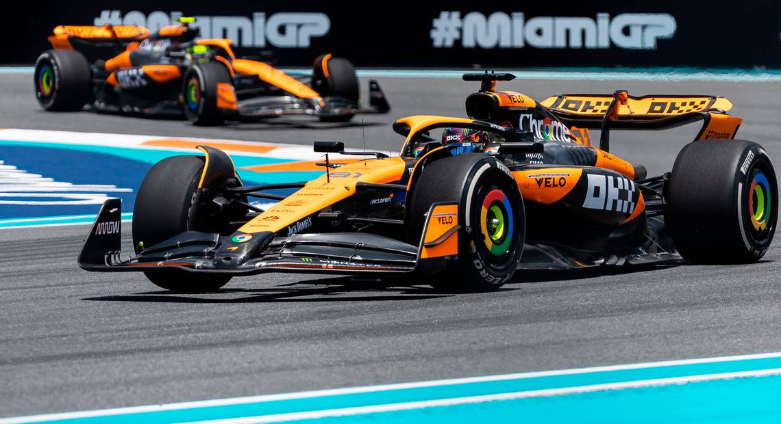 McLaren drivers Oscar Piastri of Australia and Lando Norris of Britain take turn 1 during a practice session on the first day of the Formula One Miami Grand Prix at the Miami International Autodrome on Friday, May 3, 2024, in Miami Gardens, Fla.