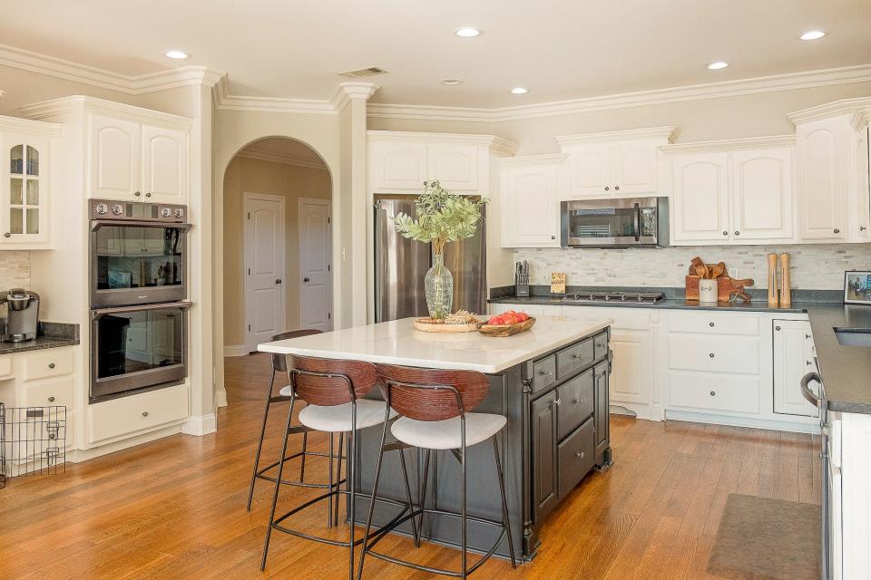 The kitchen is a cook’s dream with plenty of space for storage and food prep. White cabinets, new appliances, and an island are all perfect additions.