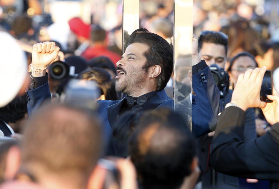 Indian film star Anil Kapoor walks the green carpet as he arrives for the 15th annual International Indian Film Awards on Saturday, April 26, 2014, in Tampa, Fla. (AP Photo/Brian Blanco)