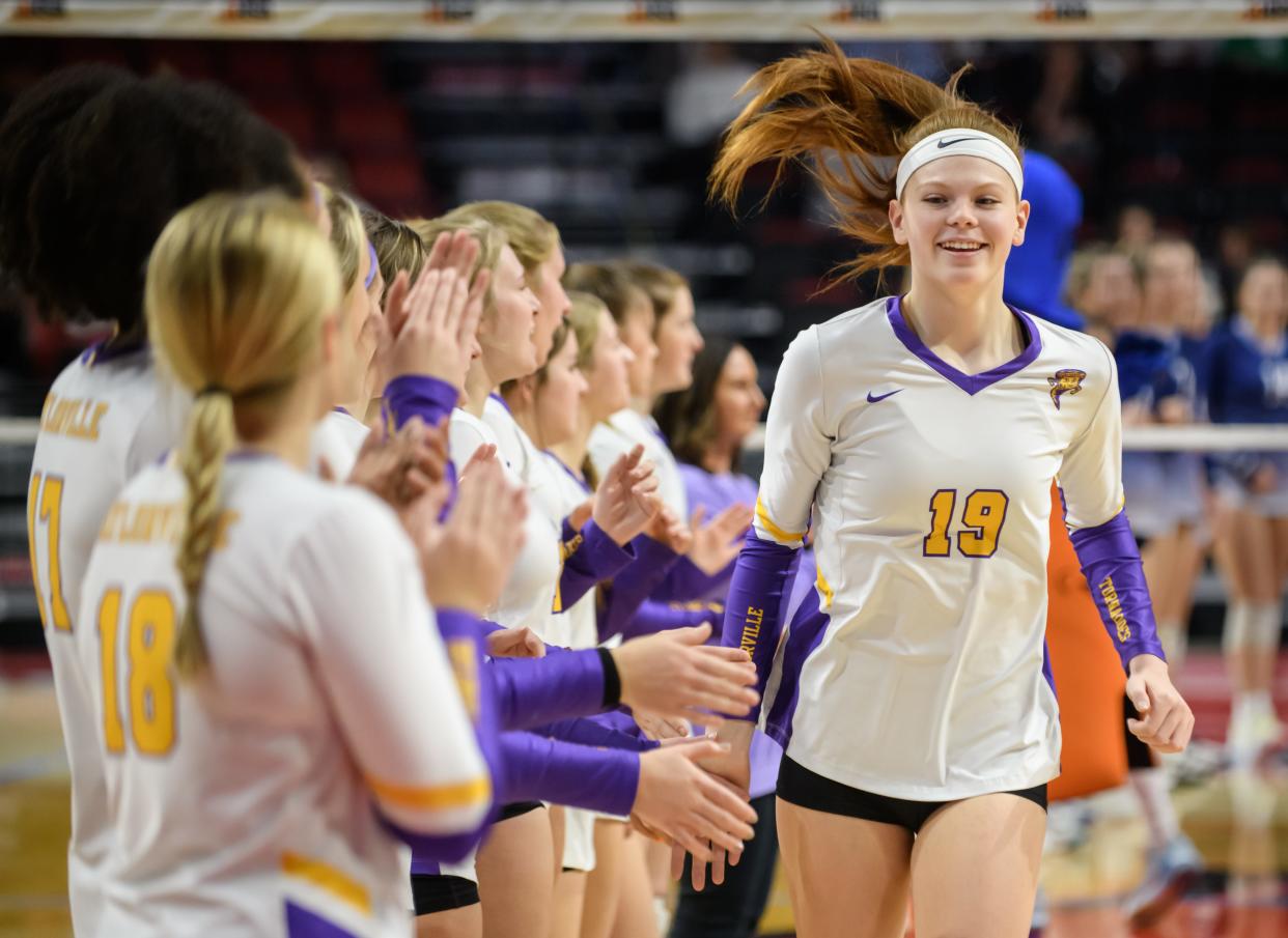 Taylorville's Mazie Fleming greets her teammate during player introductions before the start of their their Class 3A volleyball state semifinal against Nazareth Academy on Friday, Nov. 11, 2022 at CEFCU Arena in Normal.