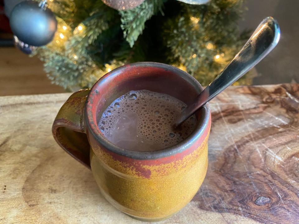 Alton Brown hot cocoa in brown mug with spoon