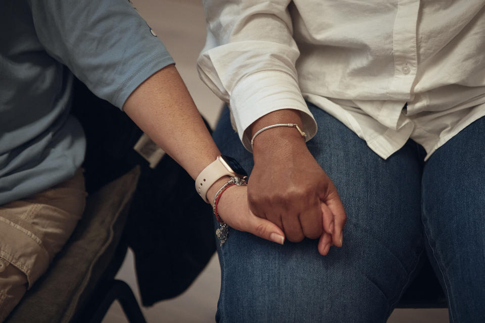 Attendees hold hands during a sexual harassment prevention class for nannies and housekeepers on Saturday, April 27, 2024, in the Brooklyn borough of New York. Nannies, housekeepers, and home care workers are excluded from many federal workplace protections in the United States, and the private, home-based nature of the work means abuse tends to happen behind closed doors. (AP Photo/Andres Kudacki)