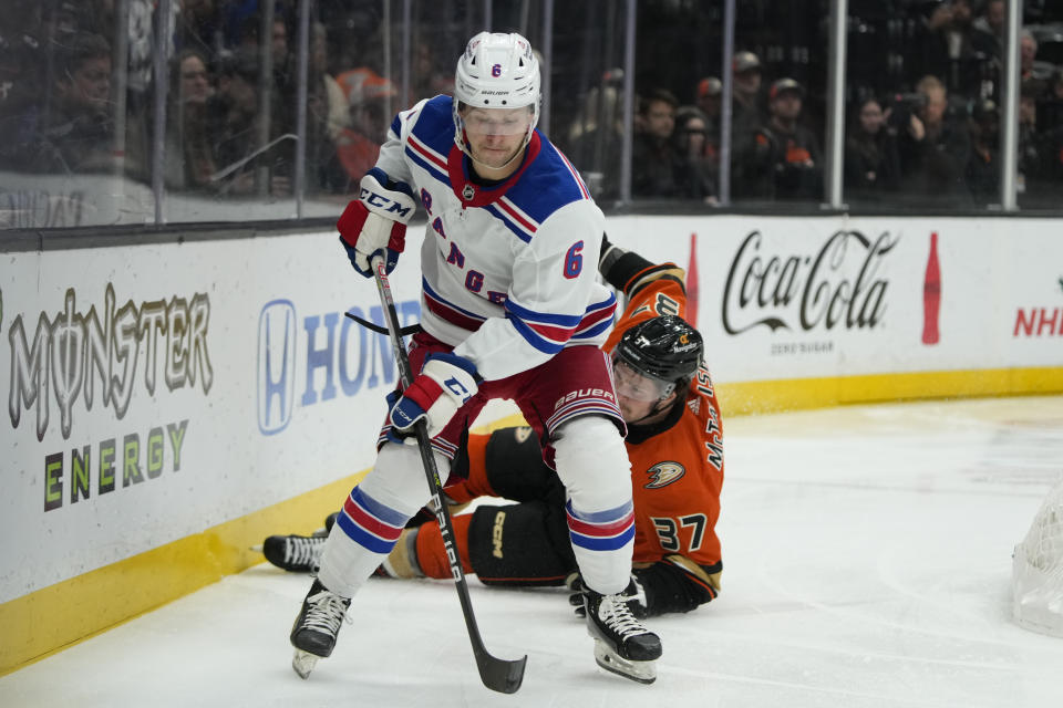 New York Rangers' Zac Jones (6) moves the puck past Anaheim Ducks' Mason McTavish (37) during the first period of an NHL hockey game Wednesday, Nov. 23, 2022, in Anaheim, Calif. (AP Photo/Jae C. Hong)