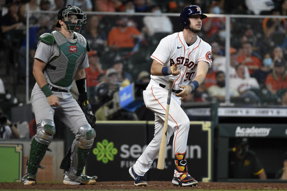 Houston Astros' Kyle Tucker, right, watches his solo home run during the seventh inning of a baseball game against the Oakland Athletics, Saturday, April 10, 2021, in Houston. (AP Photo/Eric Christian Smith)