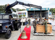 Philippine Air Force personnel unload the bells of Balangiga after their arrival at Villamor Air Base in Pasay, Metro Manila, Philippines December 11, 2018. REUTERS/Erik De Castro