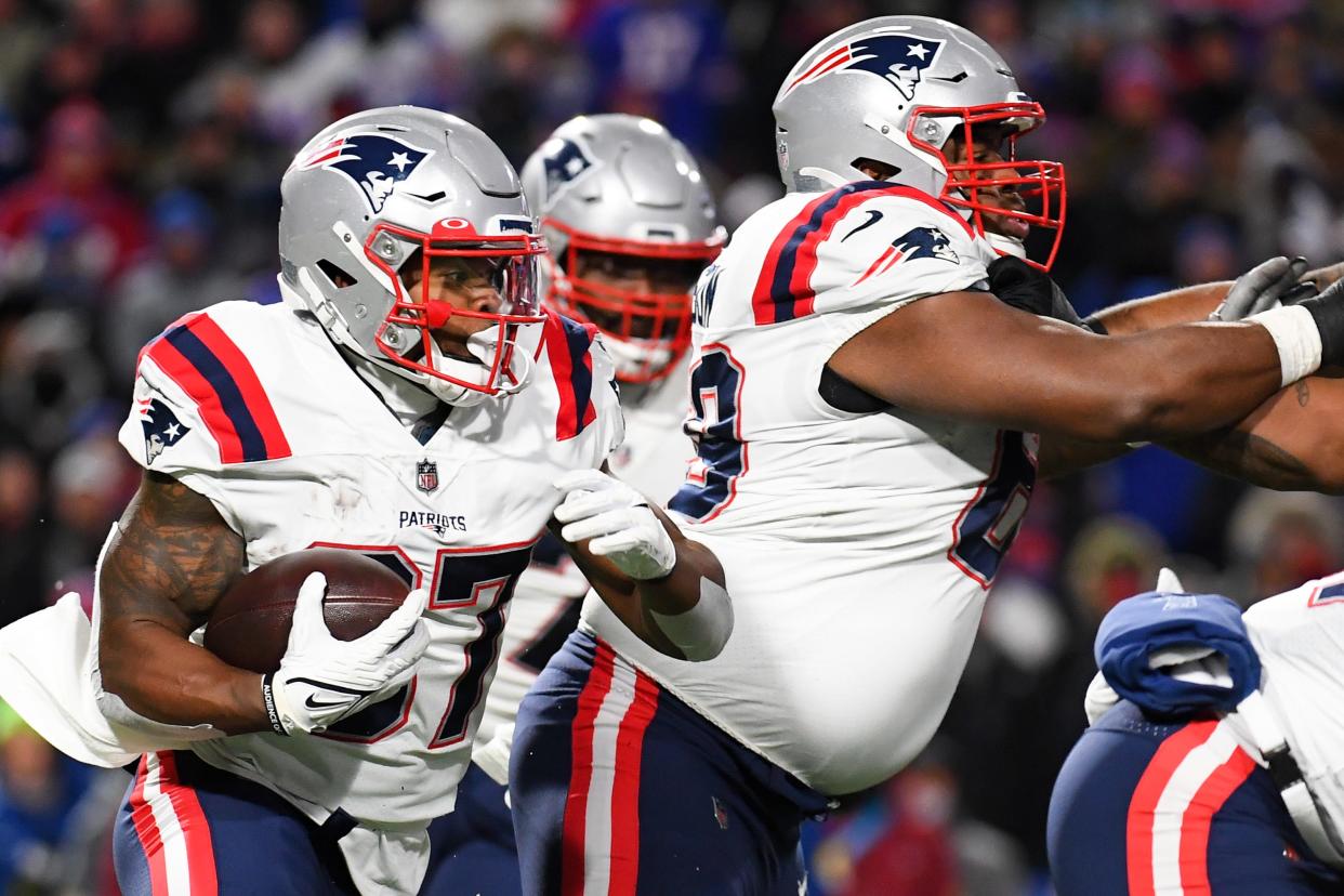 New England Patriots running back Damien Harris runs with the ball against the Buffalo Bills during the first half of a game on Monday, Dec. 6, 2021, at Highmark Stadium in Orchard Park, New York.