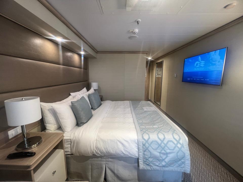 view of queen-sized bed in deluxe balcony stateroom on the Sky Princess