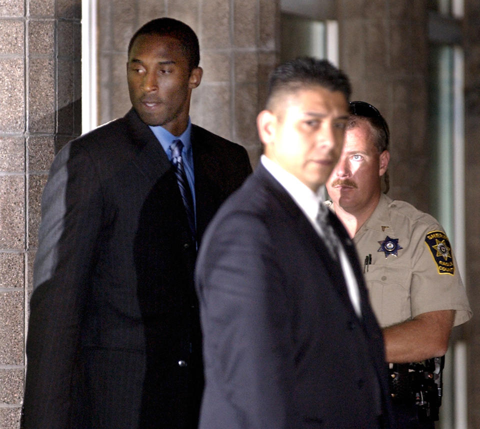 Los Angeles Lakers' star Kobe Bryant, left, leaves the Justice Center  Monday, Aug. 30, 2004 in Eagle, Colo., after spending more than 12 hours in court for a pretrial hearing and jury selection. Bryant is appearing in Eagle County District Court facing charges of sexual assault. (AP Photo/M. Spencer Green)