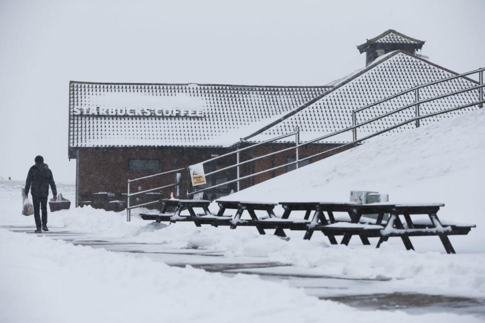 A man walks past the Starbucks Coffee store at the Membury Services on the M4 (PA)