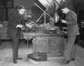 <p>Two teenage boys play with a shortwave radio as they attempt to listen to a broadcast.</p>