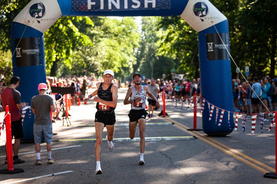 Runners finish in the elite men's race at the Fort Collins FireKracker 5K on July 2, 2022.