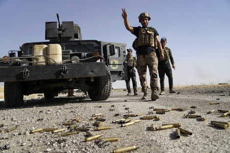 A member of Iraqi security forces gestures at Bartila in the east of Mosul during an attack on Islamic State militants in Mosul, Iraq, October 20, 2016. REUTERS/Stringer