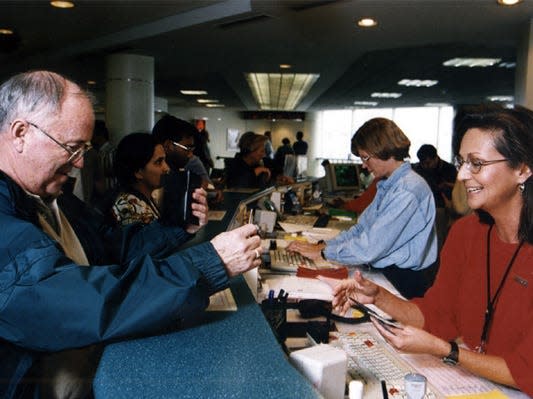 A Southwest Airlines Customer Service Agent checks in a Customer at the gate