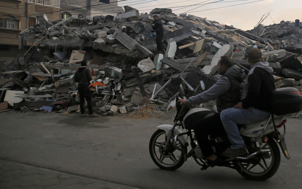 Palestinians survey a destroyed residential building hit by Israeli airstrikes, in Gaza City, Tuesday, Nov. 13, 2018. (AP Photo/Hatem Moussa)