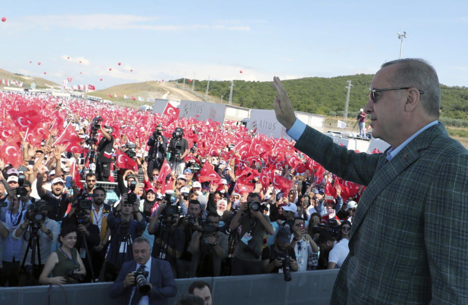 In this Sunday, Aug. 4, 2019 photo, Turkey's President Recep Tayyip Erdogan gestures as he addresses his supporters in Bursa, Turkey. US and Turkish defense officials meeting in Ankara Tuesday Aug. 6, 2019, for a second day in last-ditch negotiations on creating a safe zone in northern Syria in an area currently controlled by Syrian Kurdish forces.(Presidential Press Service via AP, Pool)