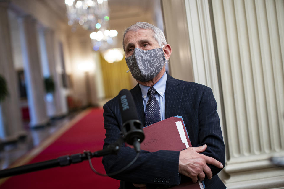 Anthony Fauci, director of the National Institute of Allergy and Infectious Diseases, wears a protective mask while speaking to members of the media before an event on the Biden administration's Covid-19 response in the State Dining Room of the White House in Washington, D.C., U.S., on Thursday, Jan. 21, 2021. (Al Drago/Bloomberg via Getty Images)