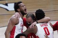 Houston forward Justin Gorham, left, head coach Kelvin Sampson and Marcus Sasser (0) celebrate after beating Oregon State during an Elite 8 game in the NCAA men's college basketball tournament at Lucas Oil Stadium, Monday, March 29, 2021, in Indianapolis. Houston won 67-61. (AP Photo/Darron Cummings)