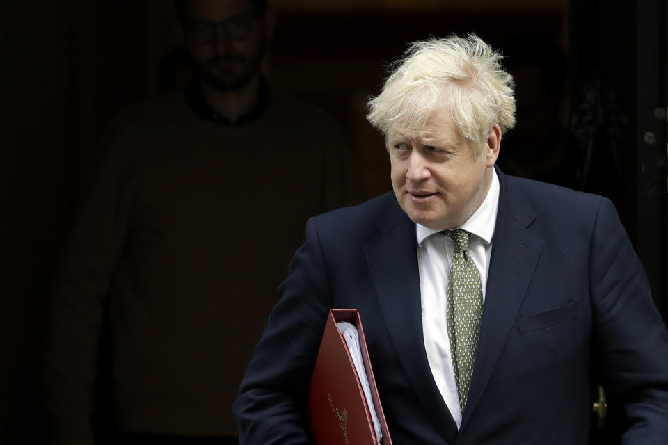 FILE - In this Friday, Oct. 23, 2020 file photo, British Prime Minister Boris Johnson walks from 10 Downing Street to a meeting with his ministers at the Foreign Office, in London. All politicians have opponents, but Boris Johnson’s list is exceptional. Amid a global pandemic, Britain’s prime minister is battling the European Union, a resurgent political opposition, angry English mayors and a beloved soccer star who wants to feed poor children.(AP Photo/Matt Dunham, file)