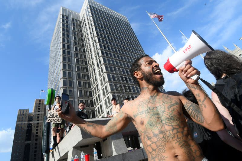 Brandon Jones, of Philadelphia cheers on the crowds as demonstrators protest against racial inequality in the aftermath of the death in Minneapolis police custody of George Floyd, in Philadelphia