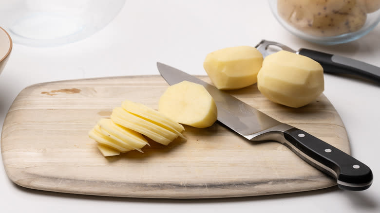 sliced potatoes on cutting board