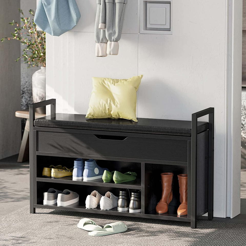 a shoe bench in a foyer filled with shoes