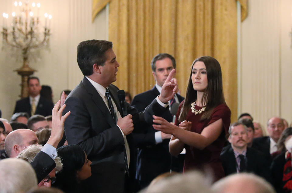 An intern moves to take the microphone from CNN's Jim Acosta during last week's press briefing. Later, the White House revoked Acosta's press pass. (Photo: Jonathan Ernst/Reuters)