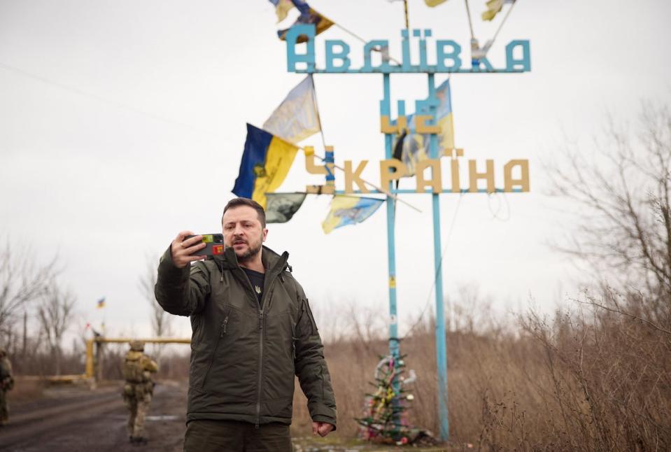 Ukrainian President Volodymyr Zelensky recording his video address in front of the sign 'Avdiivka is Ukraine (EPA)