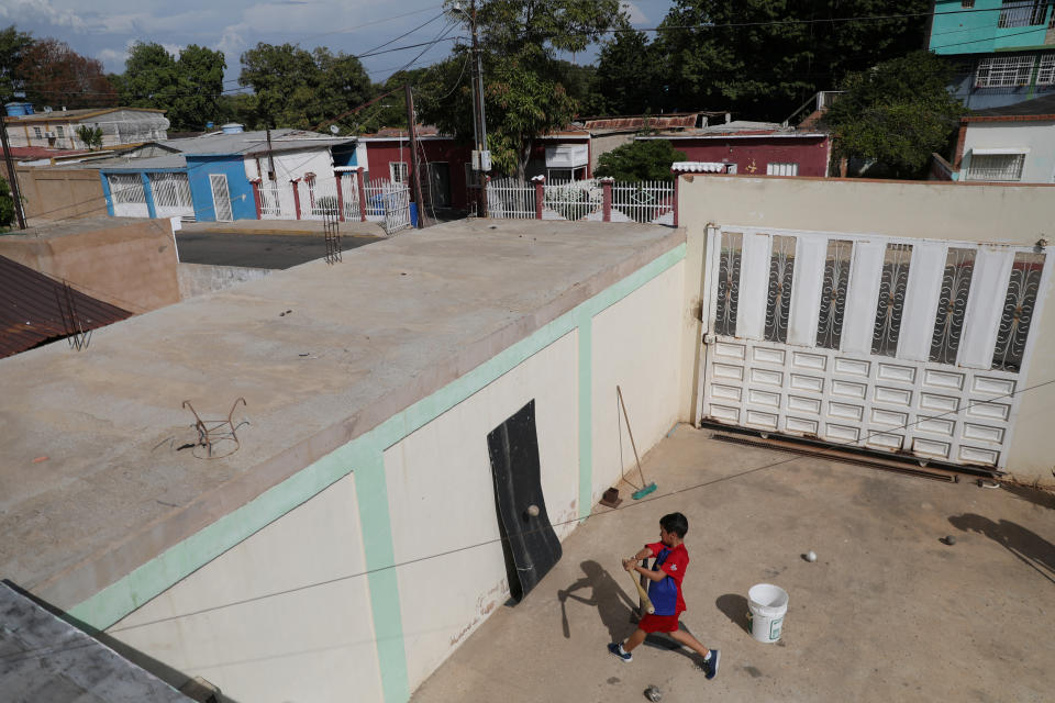 Baseball little league player Santiago Lopez, 10, practices baseball during an electricity cut at his house in Maracaibo, Venezuela.  (Photo: Manaure Quintero/Reuters)