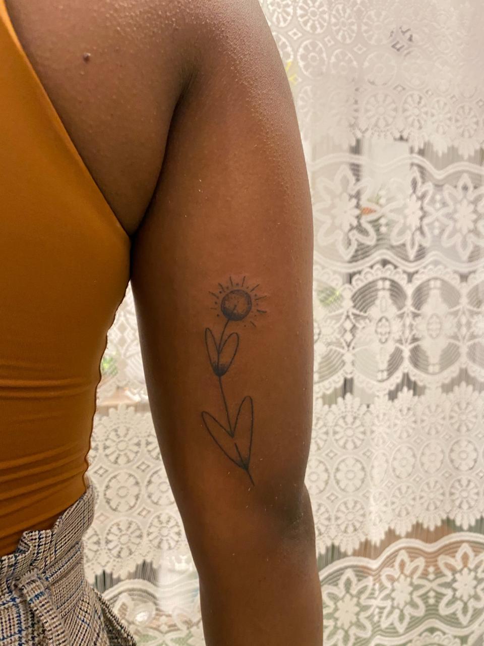 A client models a tattoo done by Tann Parker, founder of the Ink Diaspora.