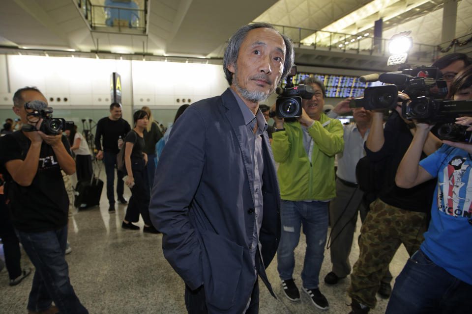 Chinese dissident writer Ma Jian arrives at Hong Kong international airport, Friday, Nov. 9, 2018. Hong Kong on Friday permitted dissident writer Ma to enter to attend a literary festival, even after an arts venue in the city canceled his appearance. Ma, whose novels frequently satirize China's communist leaders, told reporters he experienced nothing unusual while passing through passport control and that organizers were still lining-up a place for him to speak. "The lecture will definitely happen. If there is a single Hong Kong person who is willing to listen, or a single reader who contacts me, I will be there," Ma said. (AP Photo/Kin Cheung)