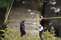 <p>A New York Police Department officer looks at the blood on the ground where medical aid was rendered to a victim at the scene where a home was destroyed by an explosion in the early morning in the Bronx borough of New York on Sept. 27, 2016. (Carlo Allegri/Reuters) </p>