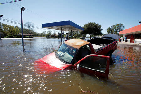 An abandoned truck lies in submerged waters in Lumberton. REUTERS/Jonathan Drake