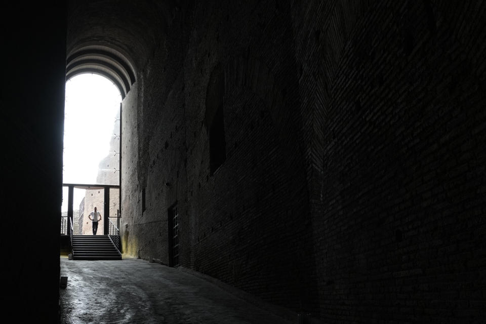 A visitor walks in the newly restored domus Tiberiana, one of the main imperial palaces, during the press preview on Rome's Palatine Hill, in Rome, Italy, Wednesday, Sept. 20, 2023. The Domus Tiberiana will reopen to the public on Sept. 21. (AP Photo/Gregorio Borgia)