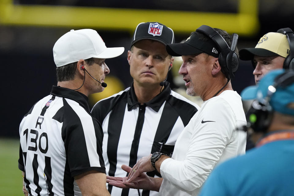 New Orleans Saints head coach Dennis Allen, right, talks with officials after throwing a challenge flag during the first half of a preseason NFL football game against the Los Angeles Chargers in New Orleans, Friday, Aug. 26, 2022. (AP Photo/Gerald Herbert)