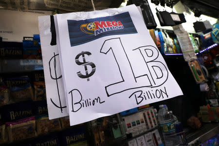 Signs display the jackpots for Mega Millions lottery drawing at a newsstands in midtown Manhattan in New York, U.S., October 19, 2018. REUTERS/Mike Sugar