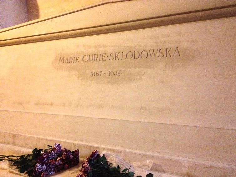 Tomb with flowers rested by it.