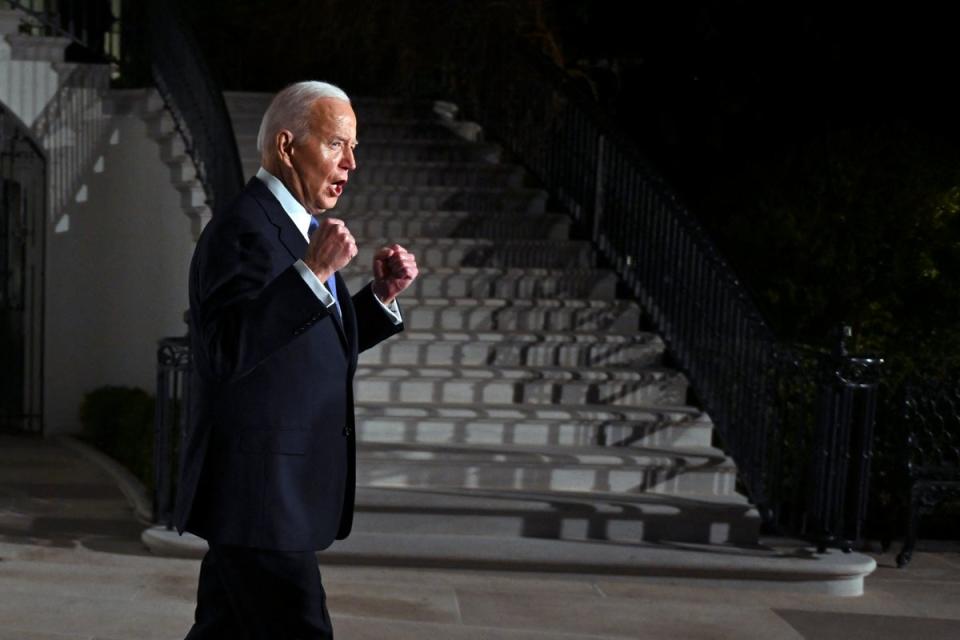 Biden gestures as he leaves the White House (AFP via Getty Images)