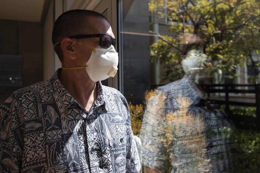 Gregory Arnold, a former guard at the Otay Mesa Detention Center, poses for a picture Tuesday, May 12, 2020, in San Diego. The early absence of facial coverings, lack of cleaning supplies and mixing symptomatic detainees with others preceded the first big outbreak at U.S. Immigration and Customs Enforcement's 221 detention centers. While the point of origin is unclear, accounts of how the virus spread at the Otay Mesa Detention Center expose shortcomings and inherent difficulties of managing the world's largest immigration detention system during a pandemic. (AP Photo/Gregory Bull)