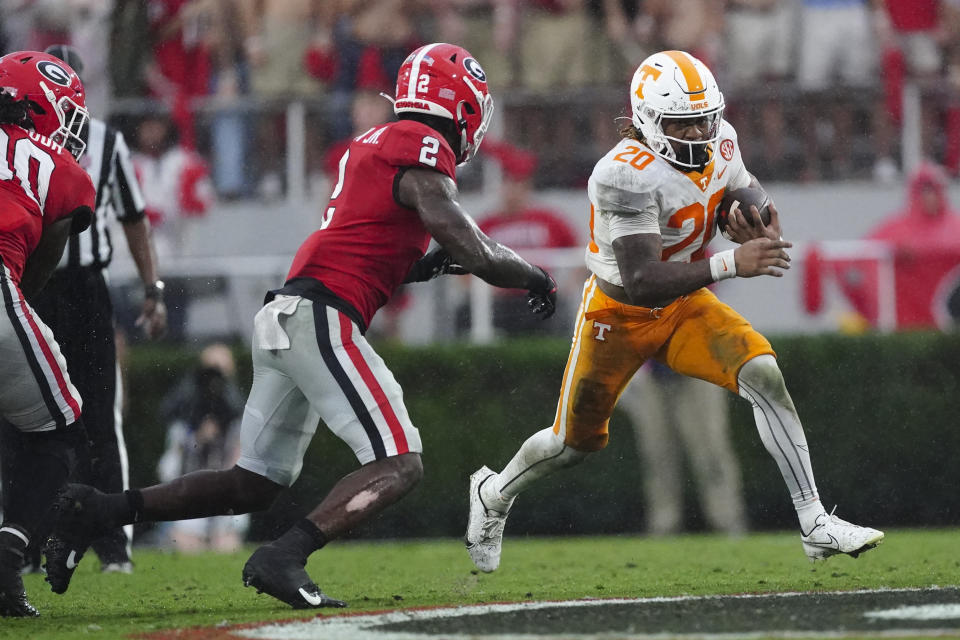 Tennessee running back Jaylen Wright (20) carries as Georgia linebacker Smael Mondon Jr. (2) defends during the second half of an NCAA college football game Saturday, Nov. 5, 2022 in Athens, Ga. (AP Photo/John Bazemore)