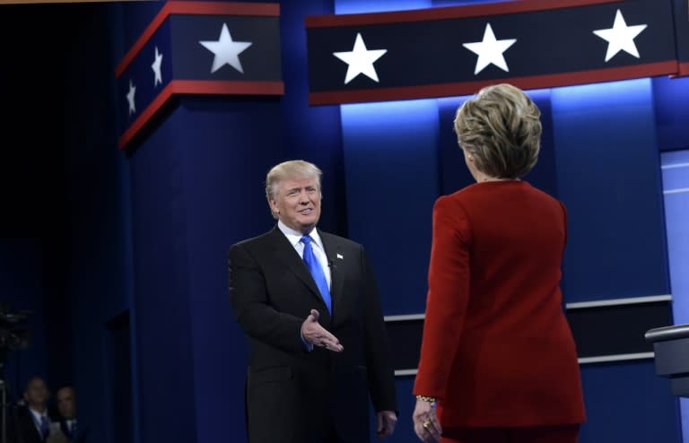 Republican presidential nominee Donald Trump (L) and Democratic presidential nominee Hillary Clinton arrive on stage for the first presidential debate